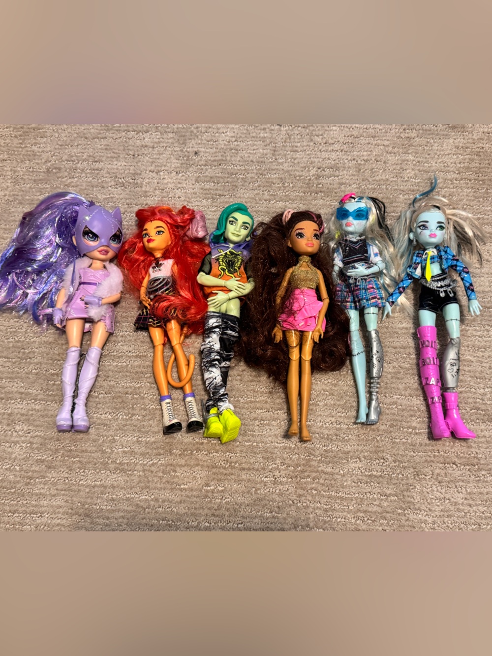 monster high dolls set with purple pink teal blue and yellow accents